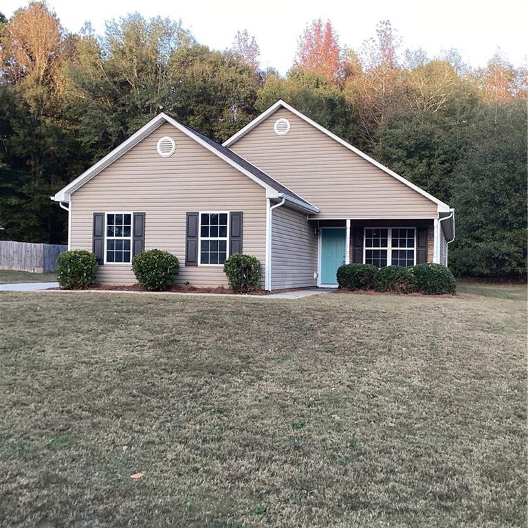 a front view of house with yard and green space