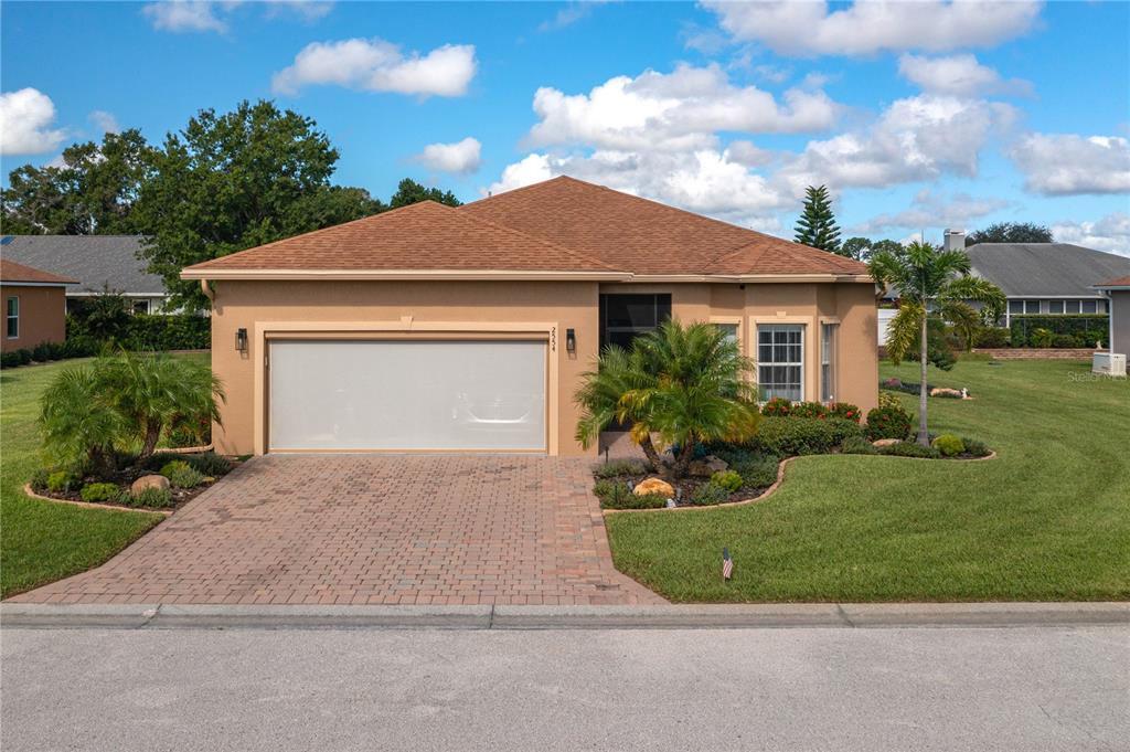 a front view of a house with a yard and garage