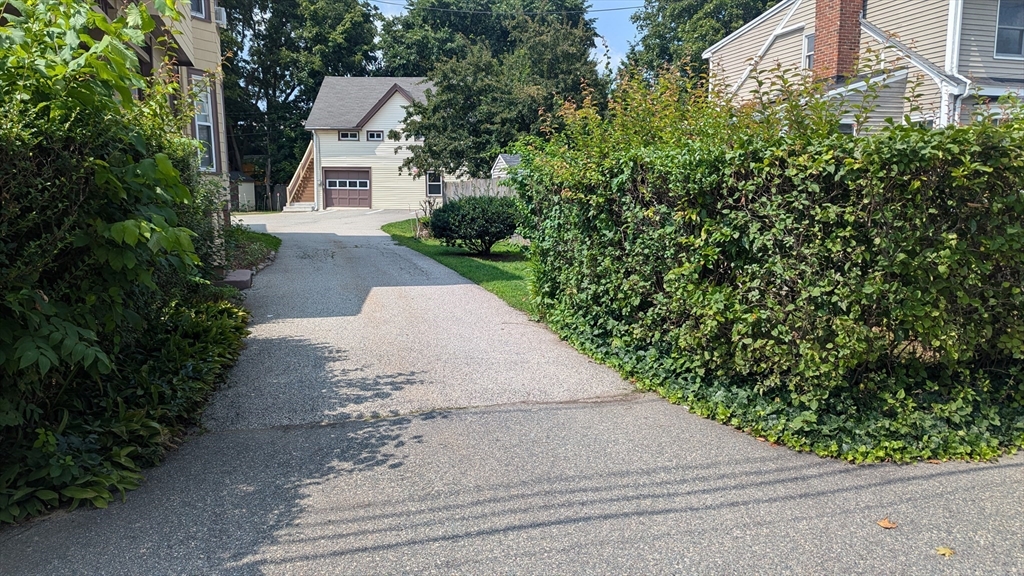 a front view of a house with a yard and trees