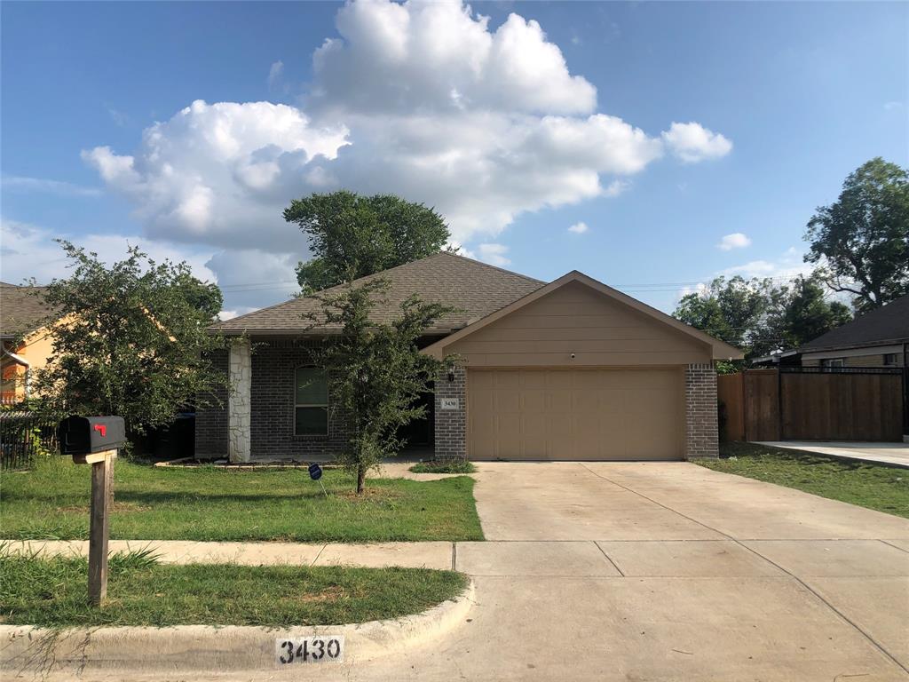 a front view of a house with a yard and entertaining space