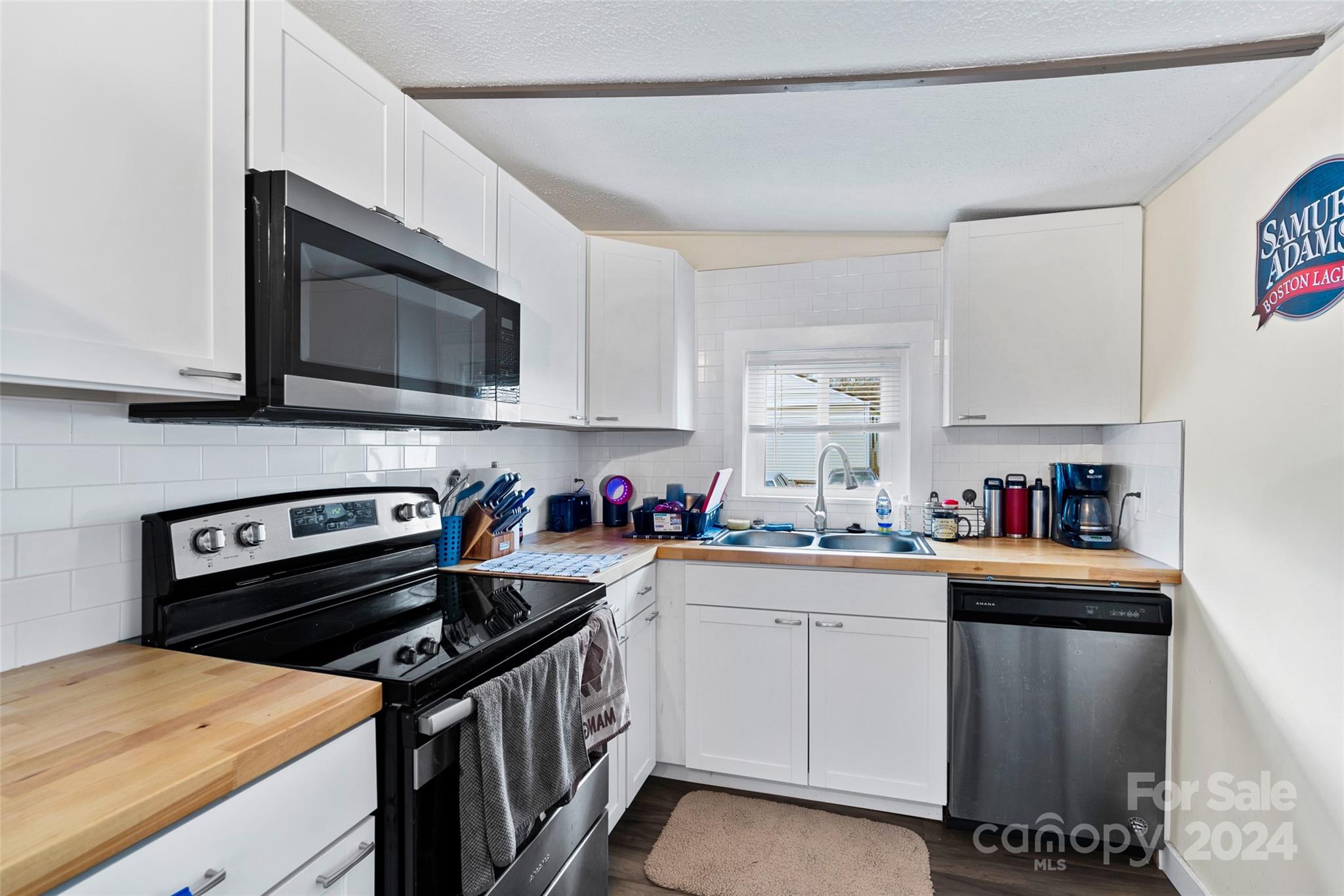 a kitchen with a stove sink and microwave