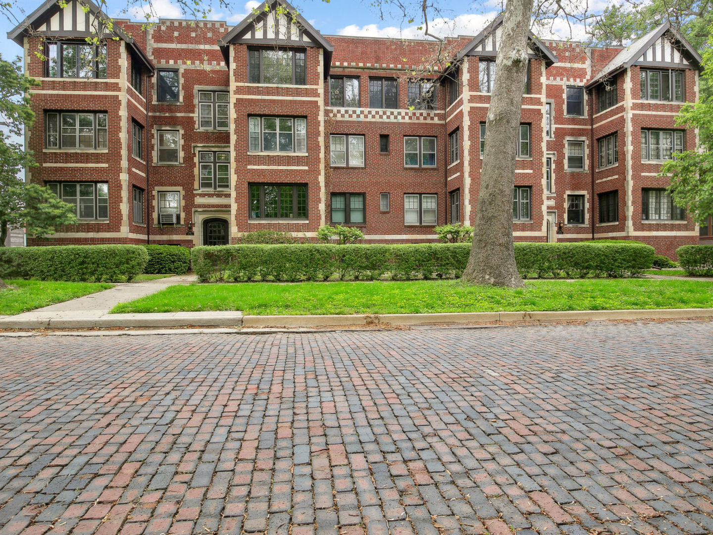 a view of a brick building next to a yard