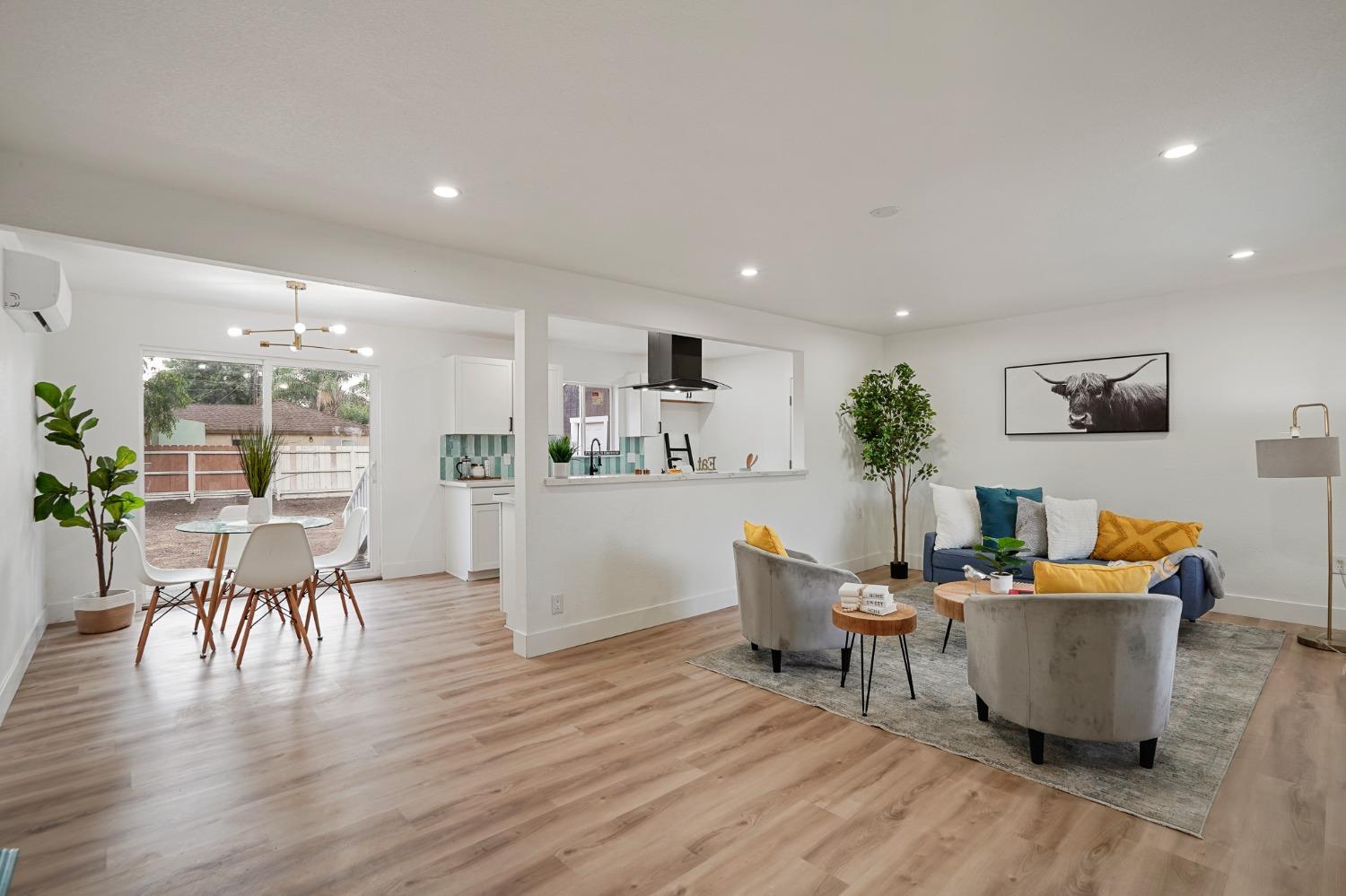 a living room with furniture wooden floor and a flat screen tv