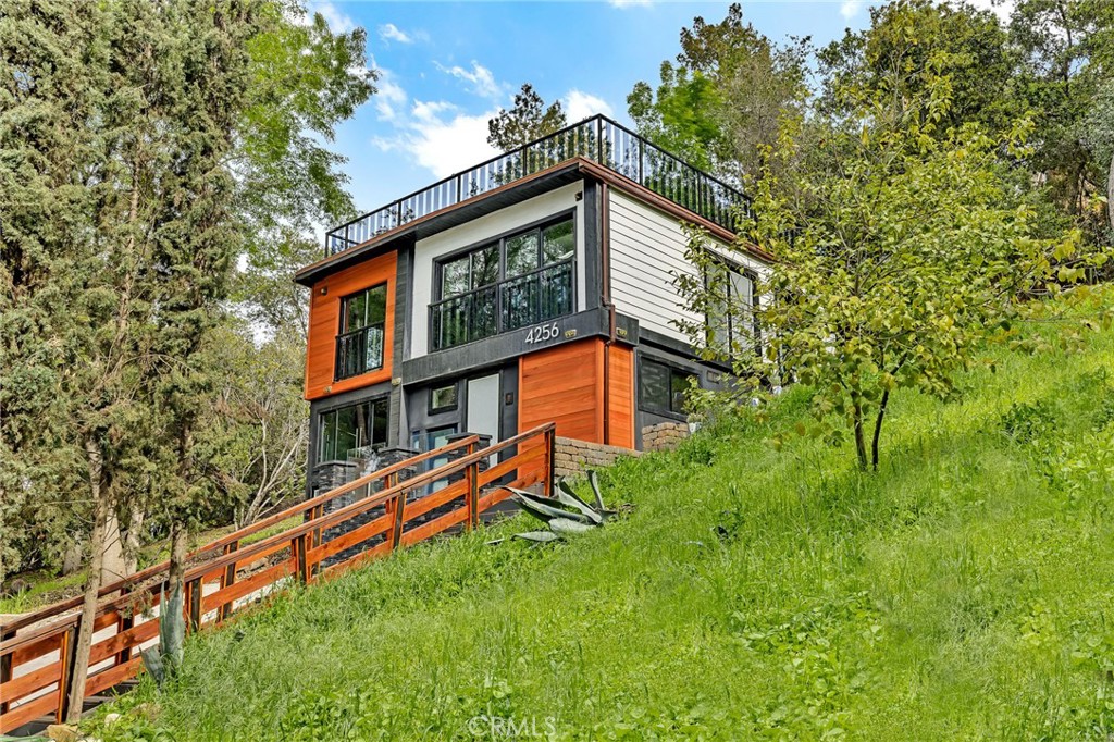 a backyard of a house with lots of green space and fountain