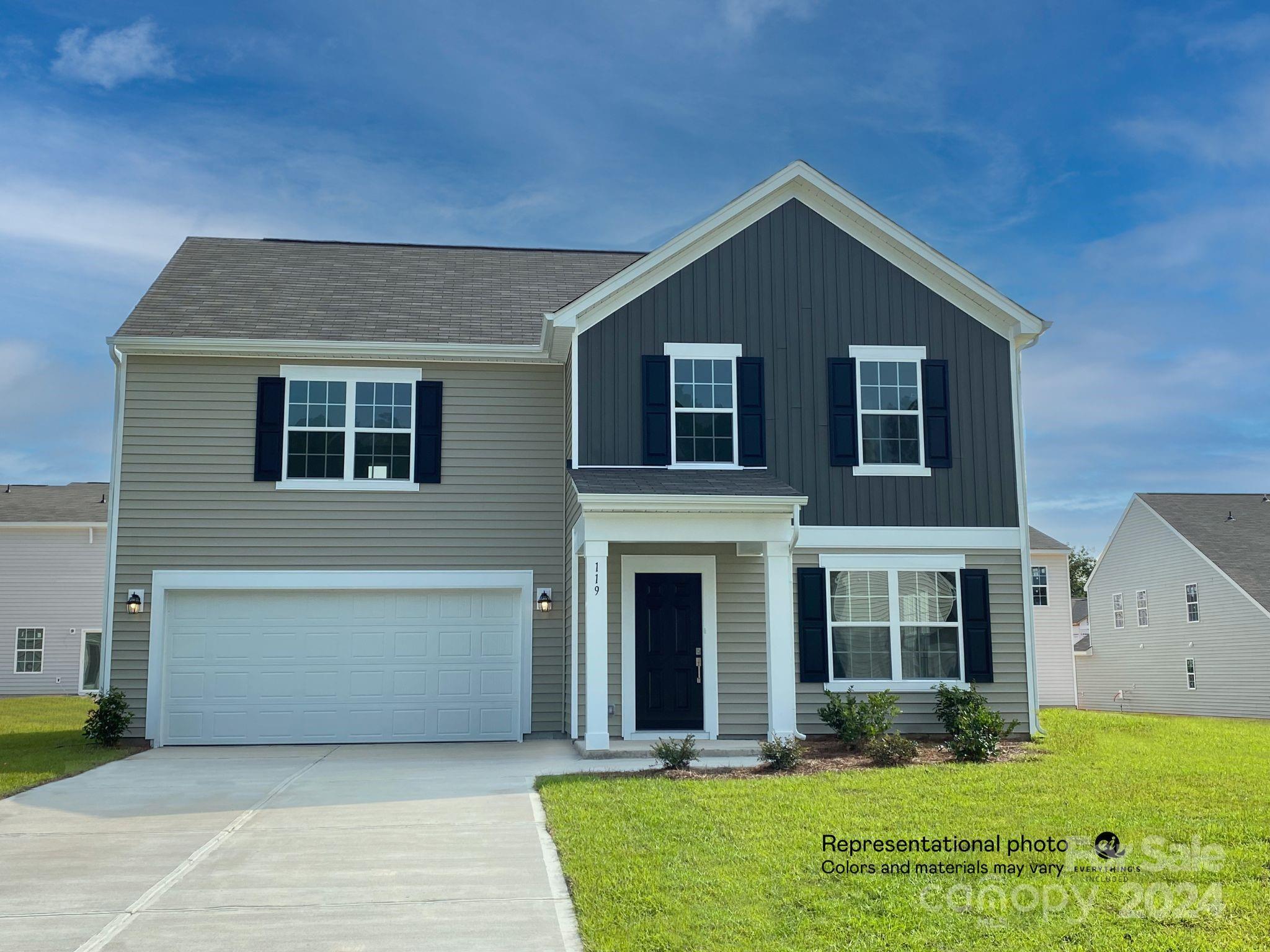 a front view of house with yard and green space