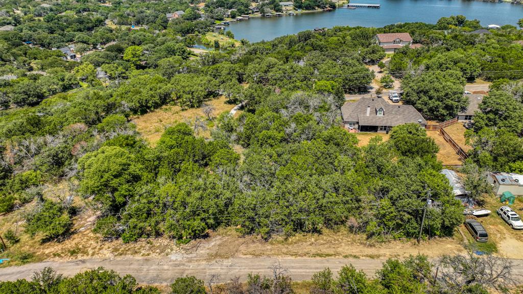 an aerial view of a house with a yard and lake view