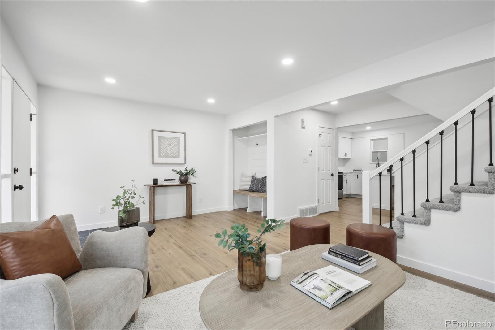 a living room with furniture and a potted plant