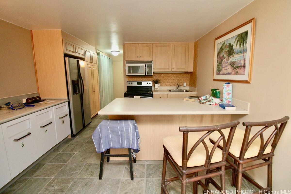 a kitchen with stainless steel appliances a refrigerator and a stove top oven