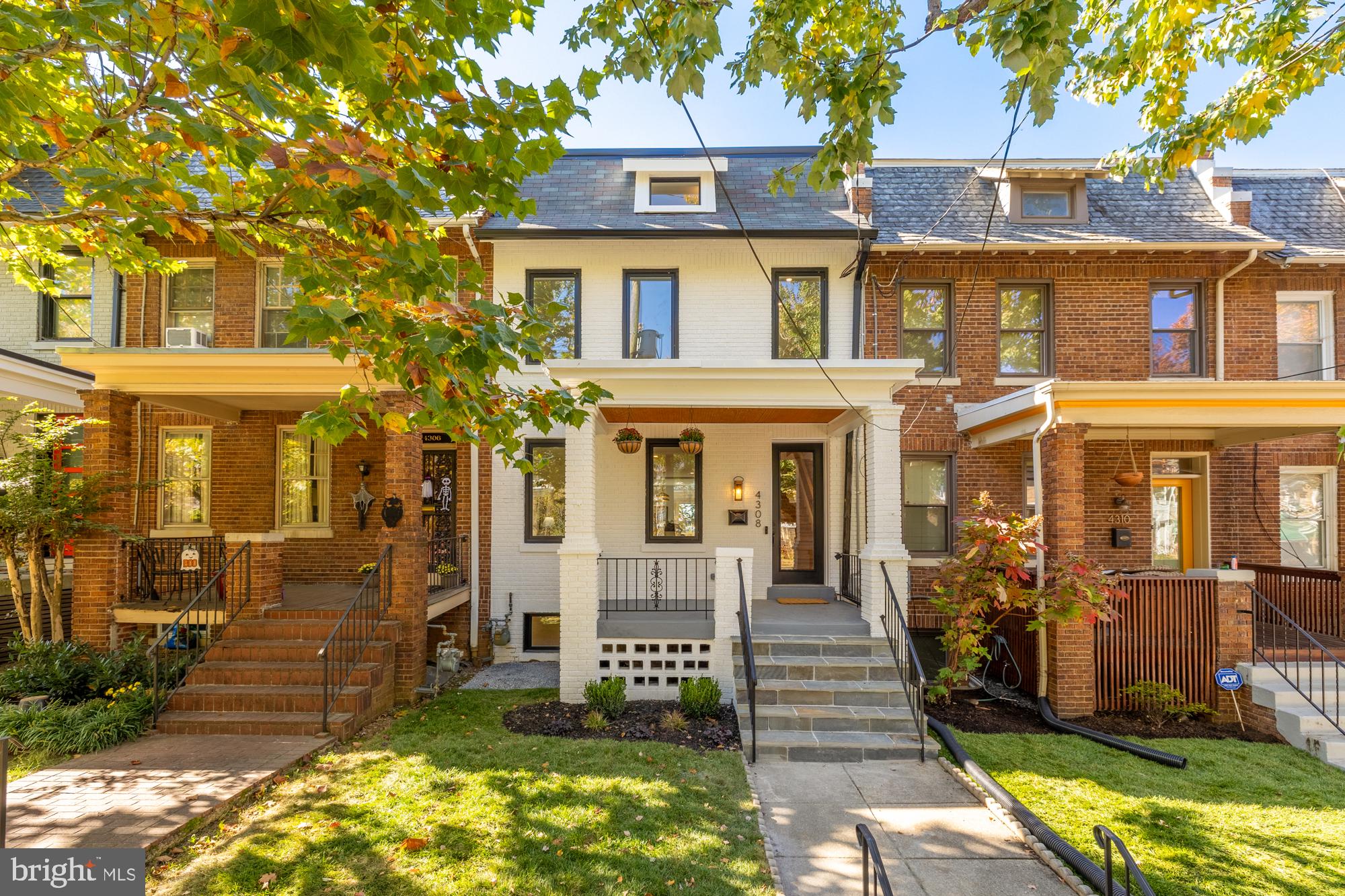 a front view of a residential apartment building with a yard