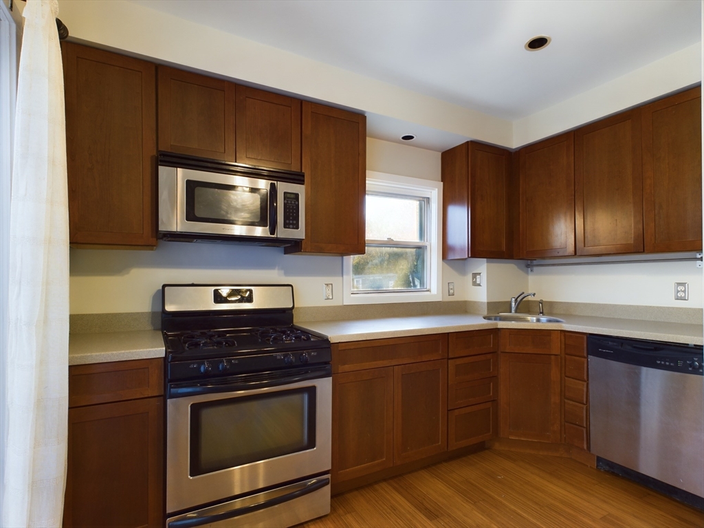 a kitchen with a sink and steel appliances