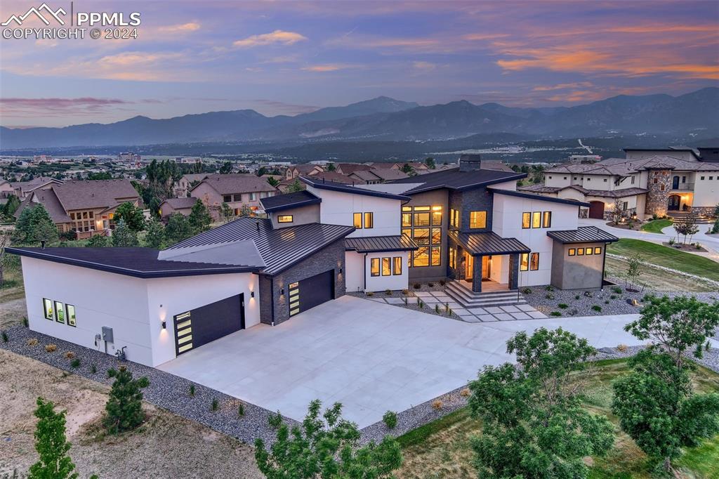 View of front facade with a mountain view and a garage