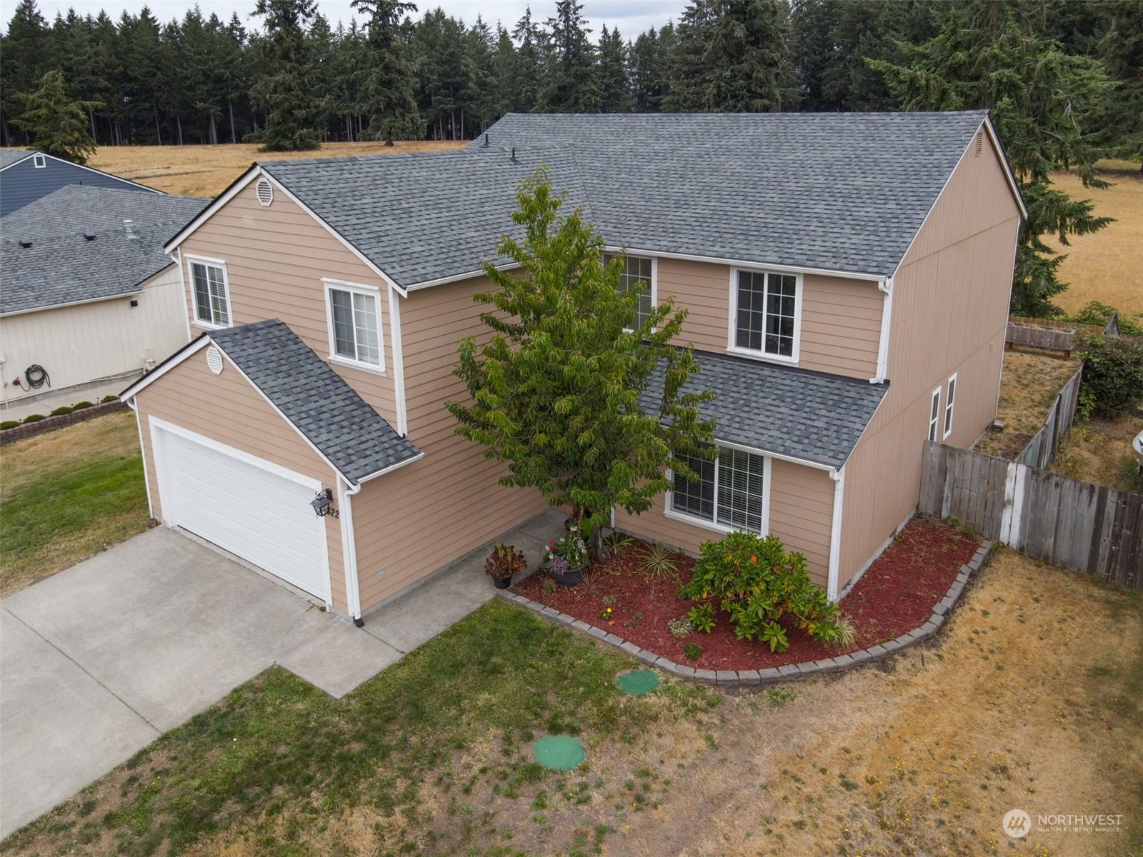 a aerial view of a house next to a yard