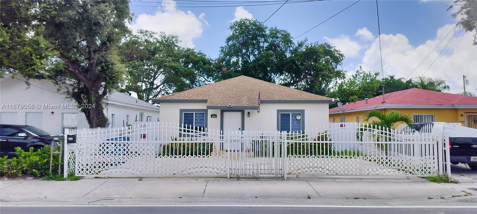 a front view of a house with a garden and plants