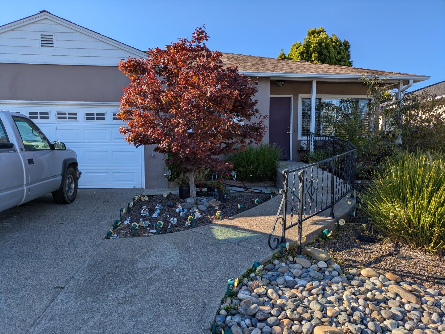 a view of a house with a yard patio and furniture