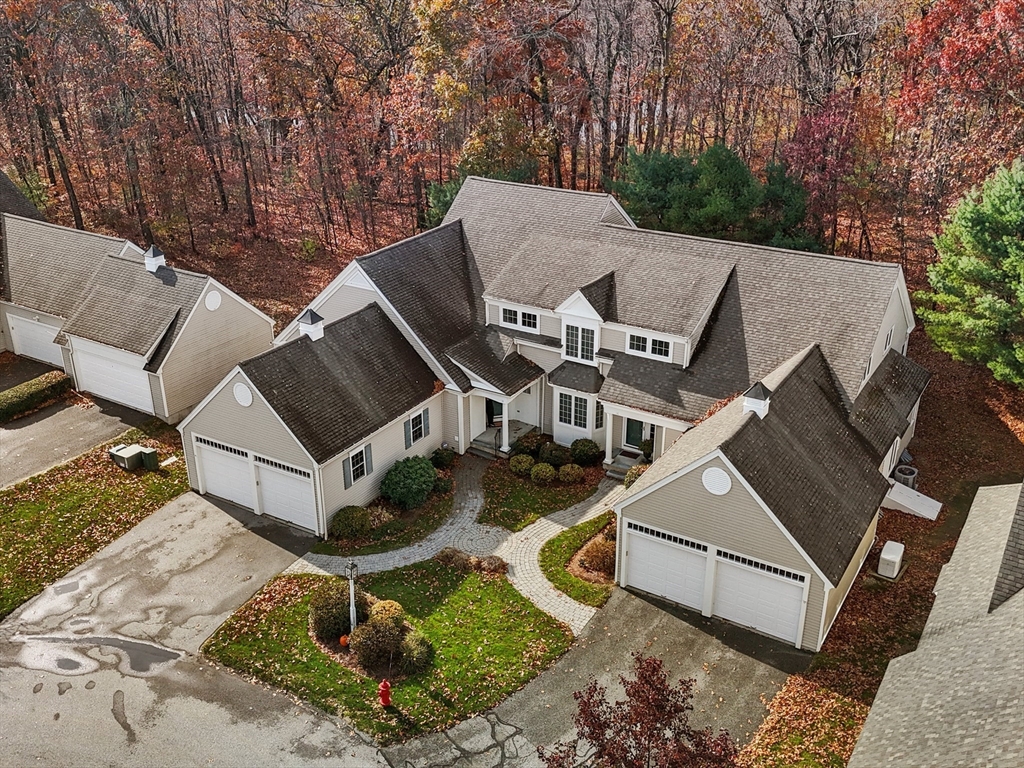 an aerial view of a house with backyard