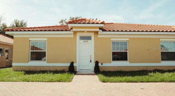 a front view of a house with a garden