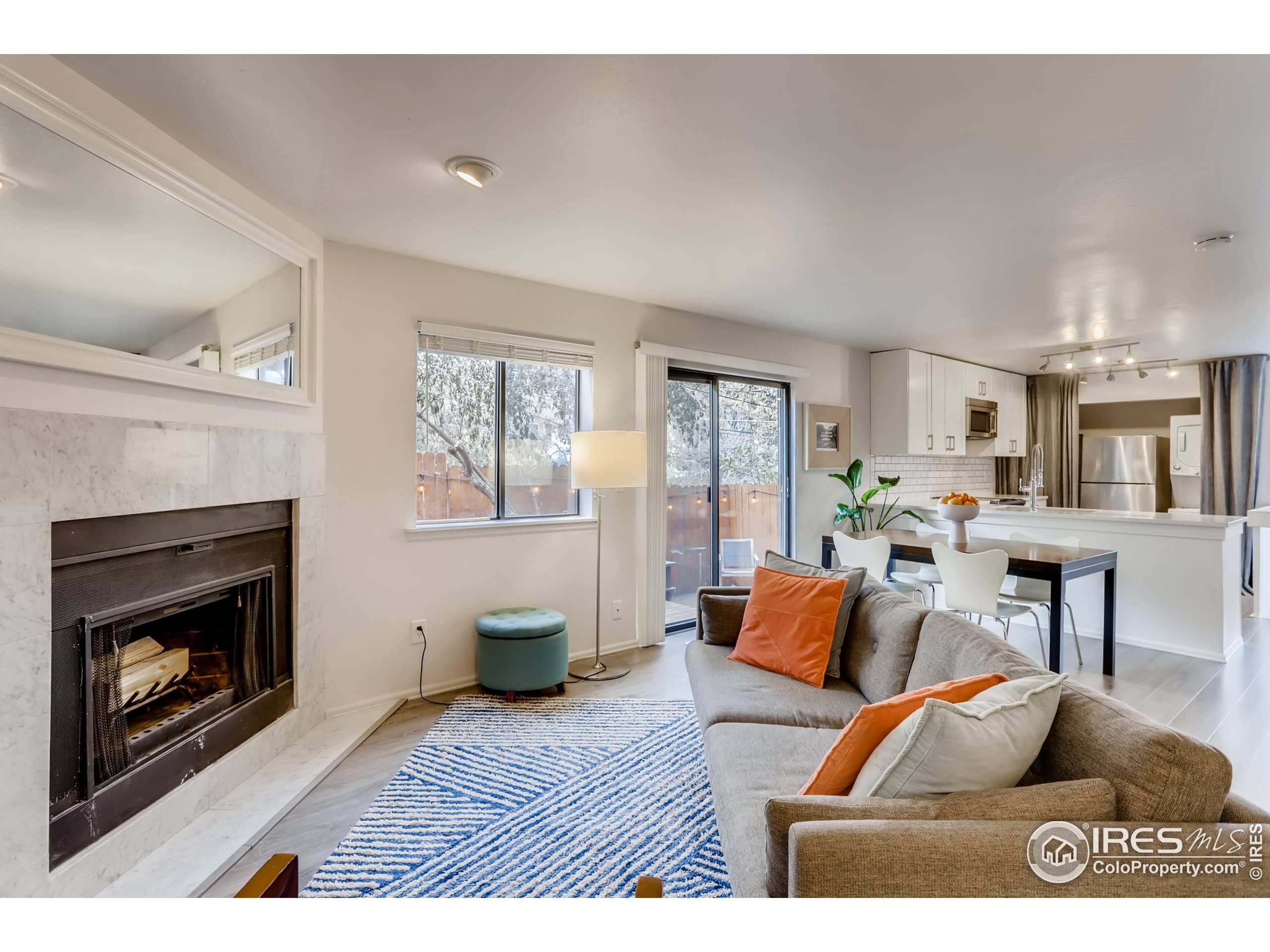 a living room with furniture a fireplace and a window