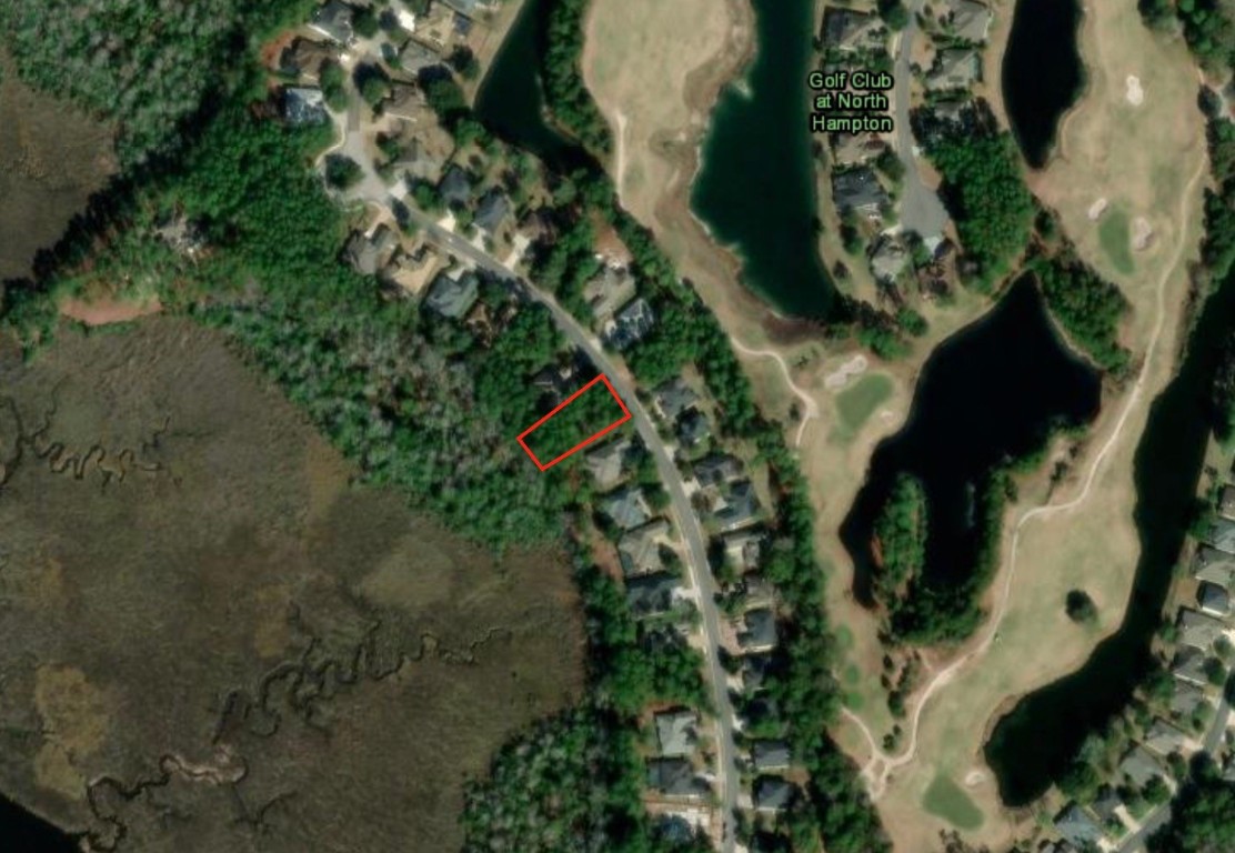 an aerial view of a house with a yard and plants