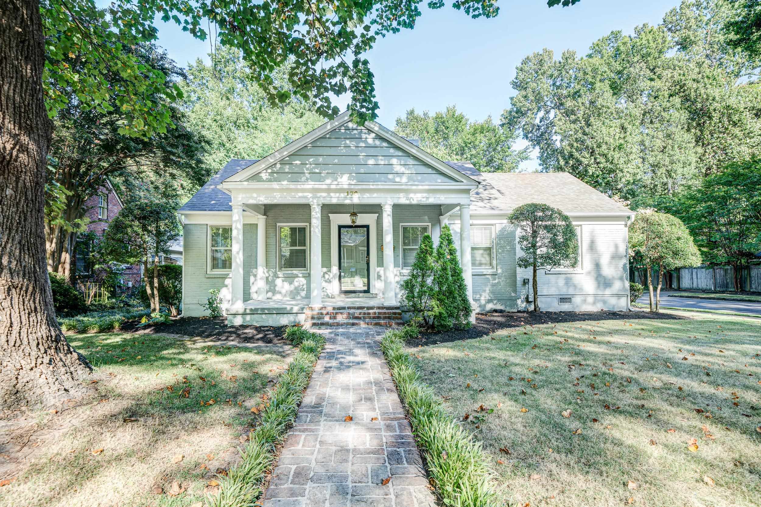 View of front facade with a front yard and covered porch