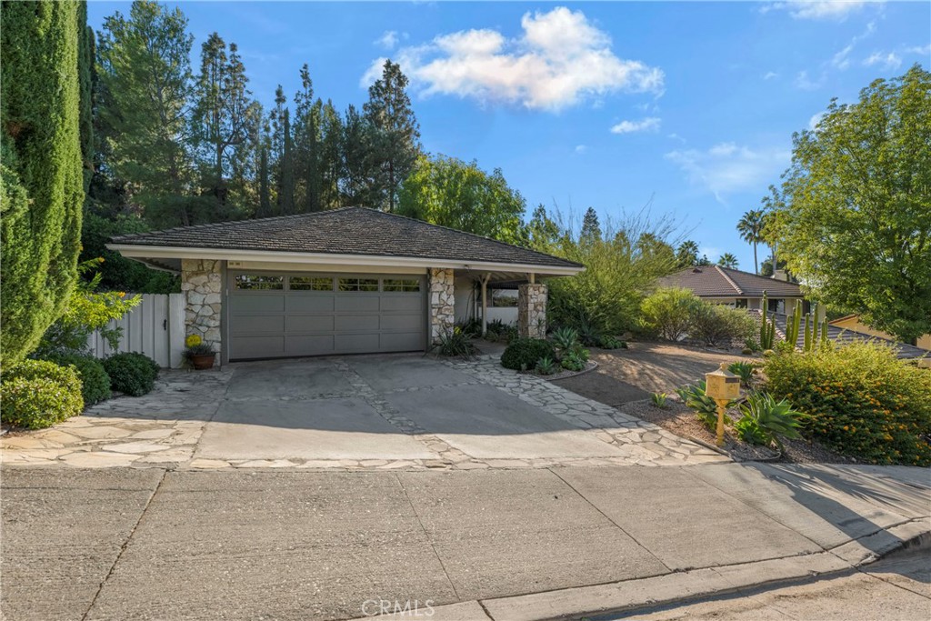 a view of house with outdoor space and garden