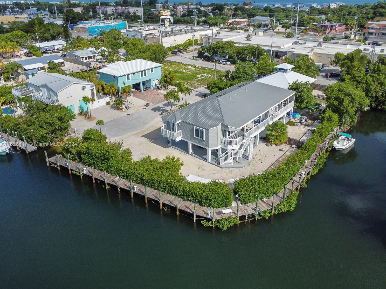 an aerial view of a house with a garden and lake view