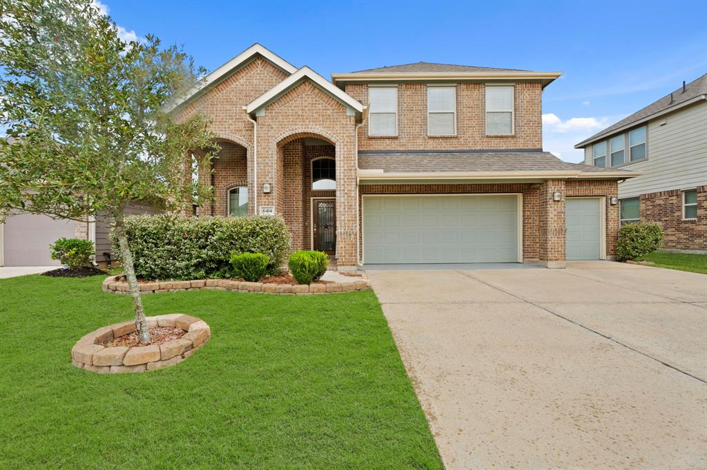 a front view of a house with a yard and garage