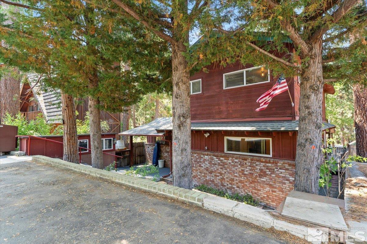 front view of a house with a tree