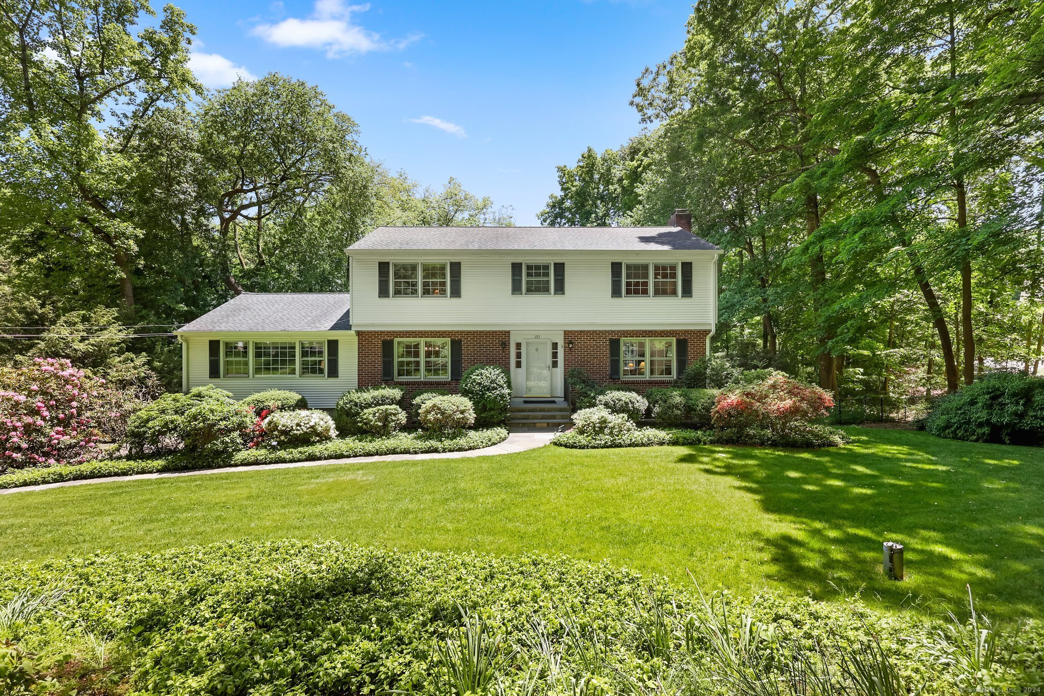 a front view of a house with garden and porch