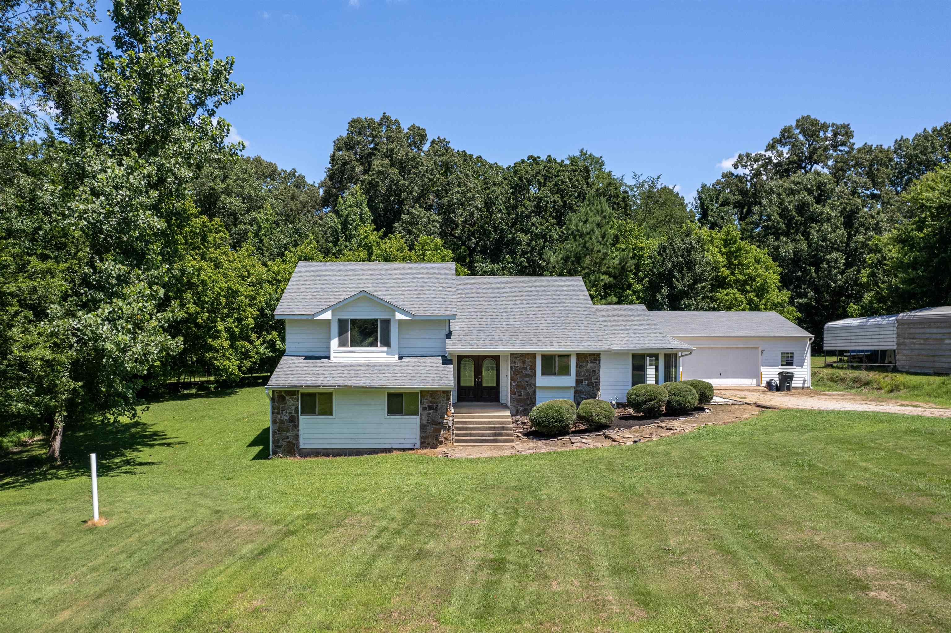 Tri-level home with a front lawn