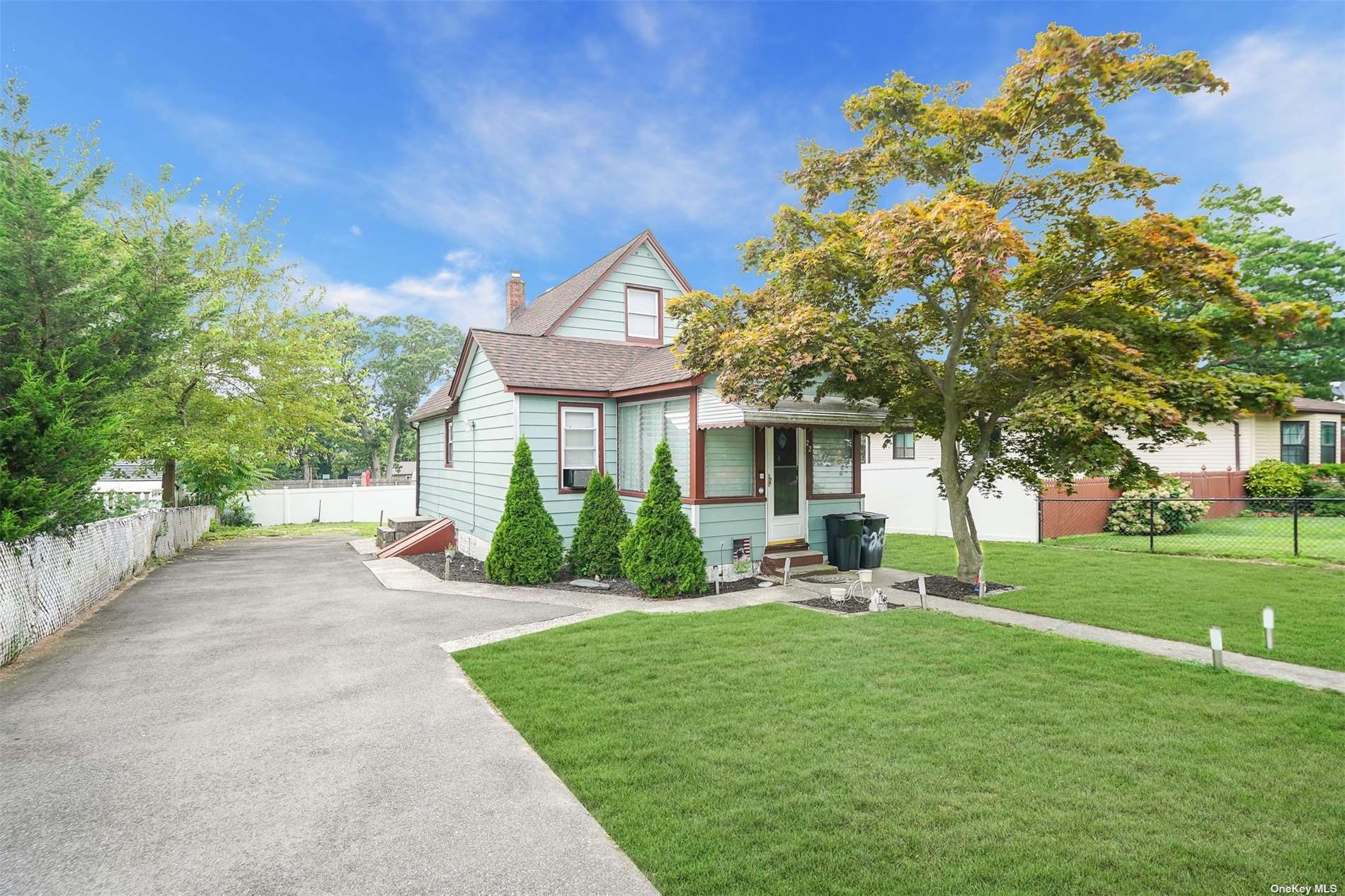 a front view of a house with a yard porch and outdoor seating