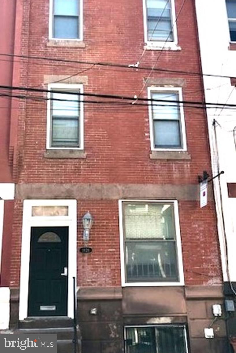 a brick building with a door and a window