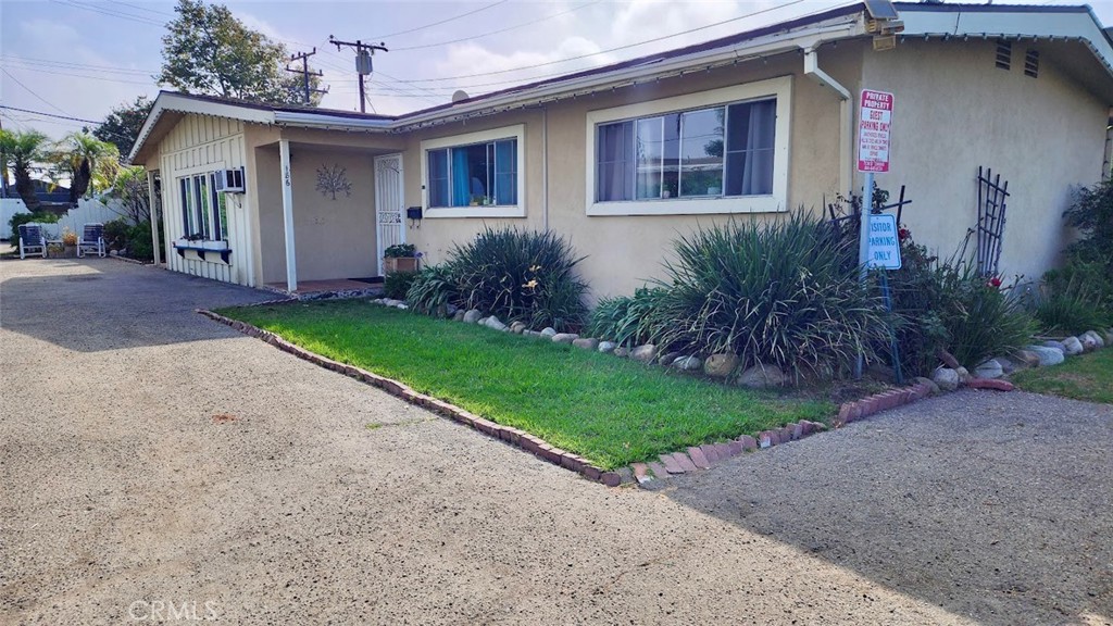 a front view of a house with garden