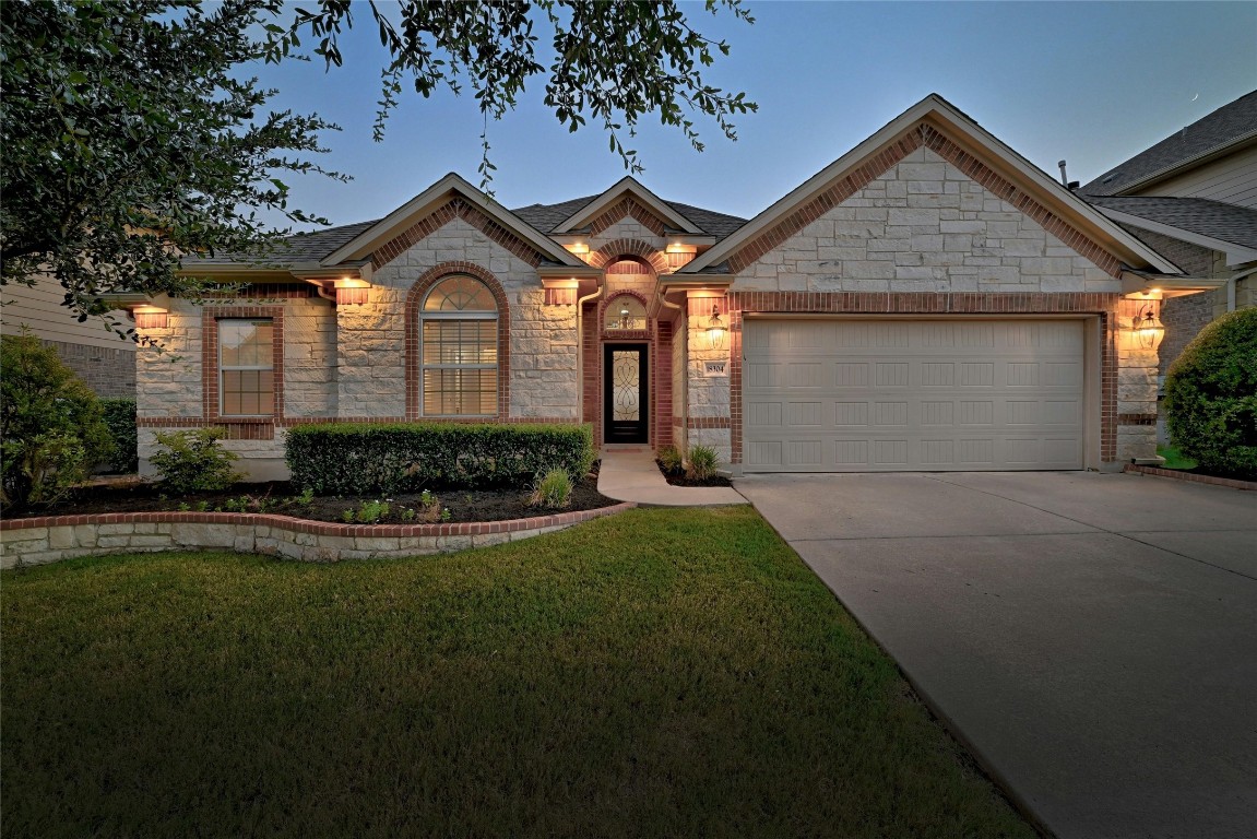 a front view of a house with a yard and garage