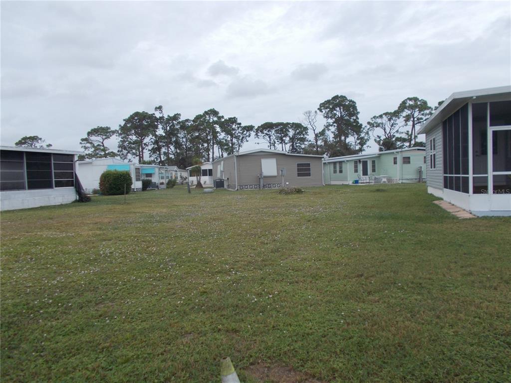 a view of a house with a yard and sitting area