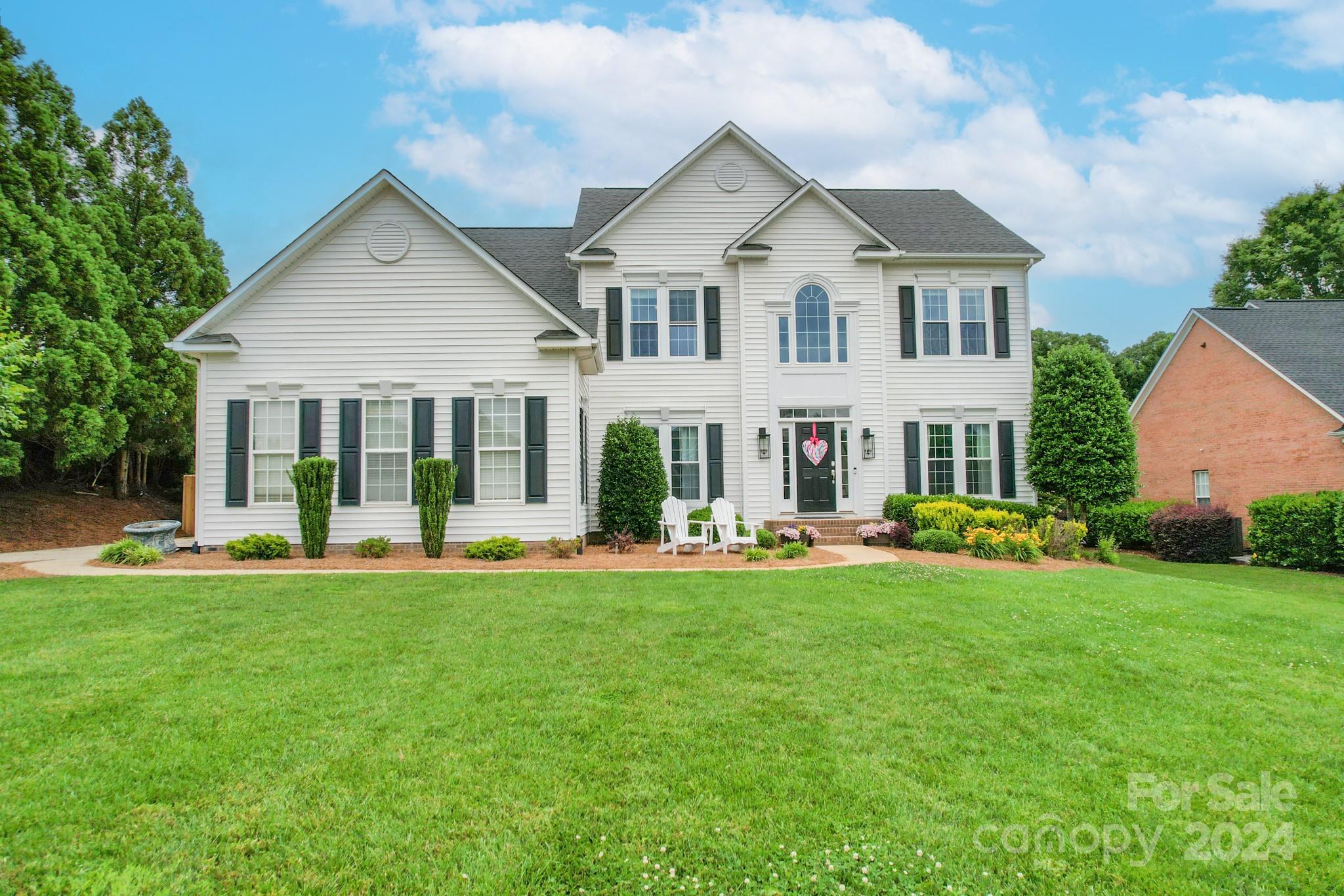 a front view of a house with a garden and porch