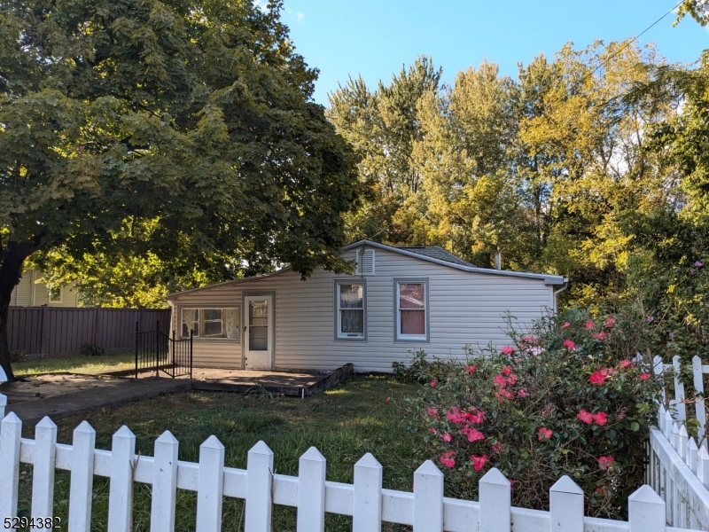 a front view of house with yard and trees