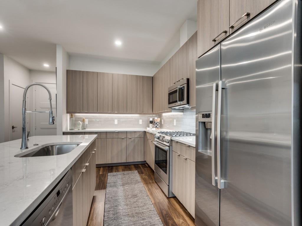 a kitchen with a sink stove and refrigerator