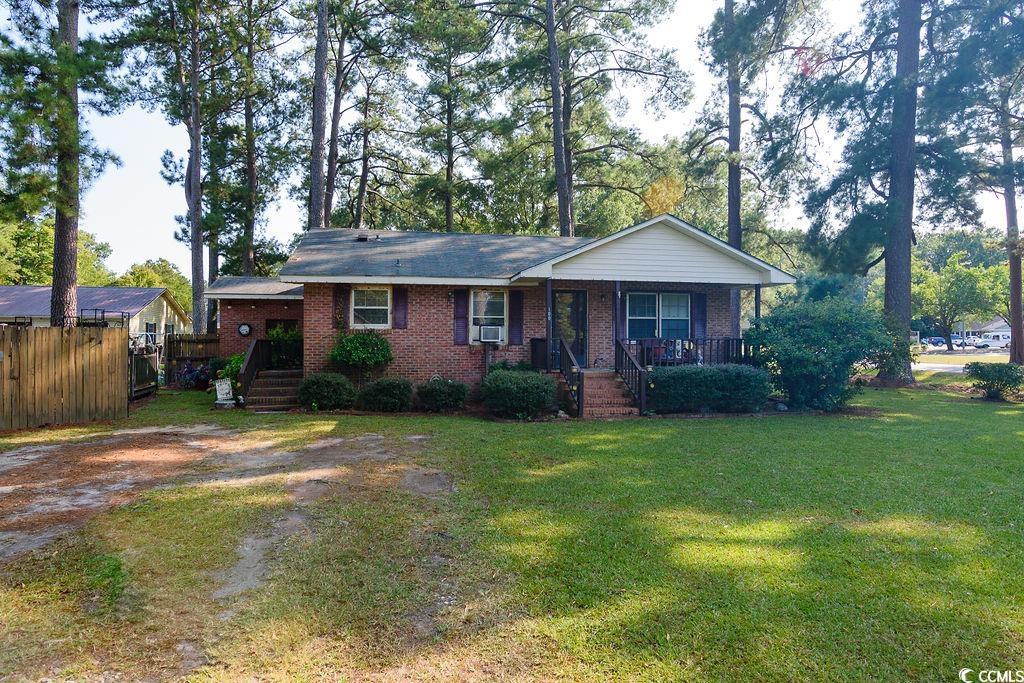 Ranch-style house featuring a front yard, a porch,