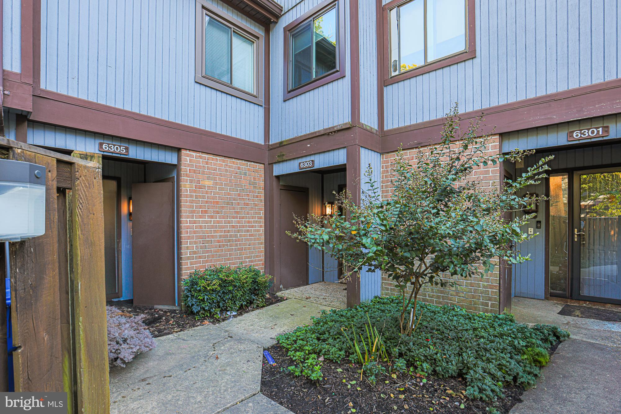 a view of a house with potted plants