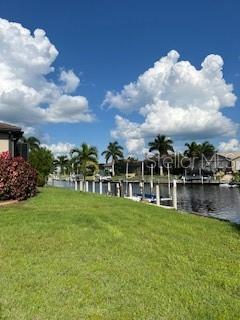 a view of a lake with houses in back