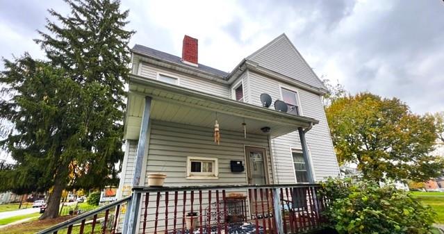 a view of a house with a large window and potted plants