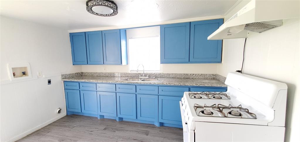 a kitchen with granite countertop cabinets and white appliances