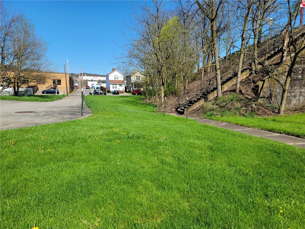 a view of yard with swimming pool and green space