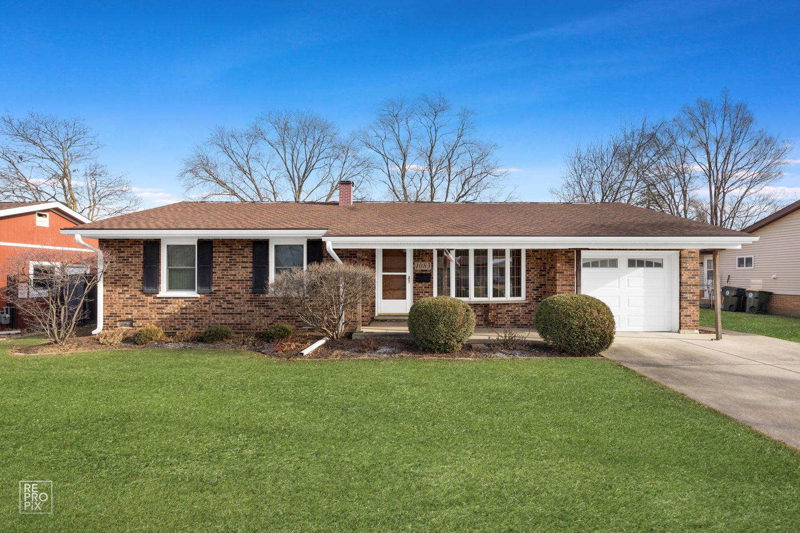 a view of a house with a backyard