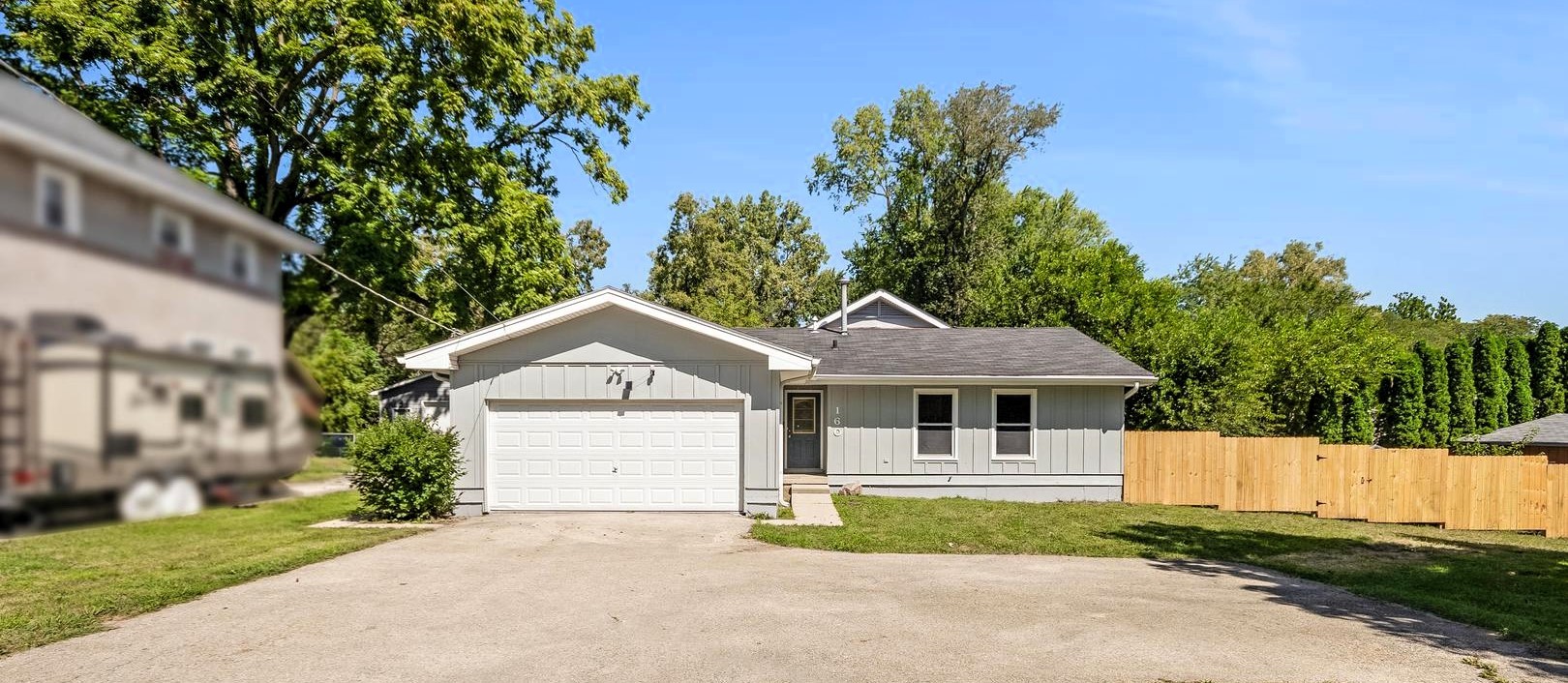 a front view of a house with a garden and garage