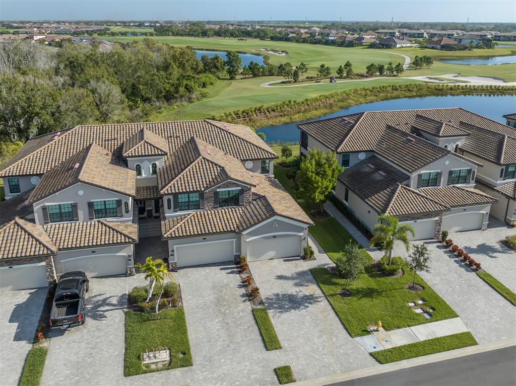 an aerial view of a house with a garden and lake view