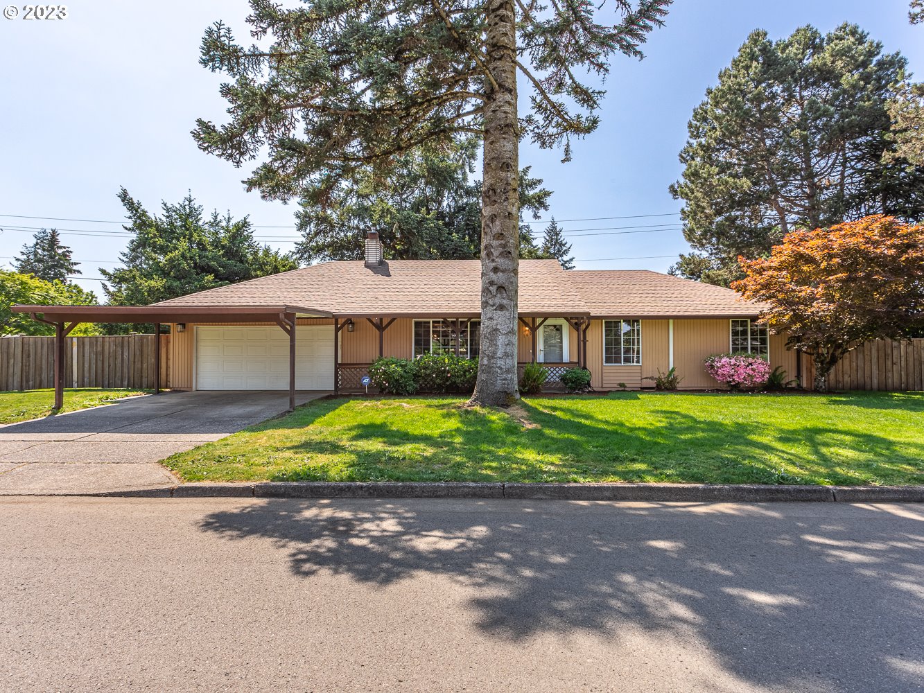 a front view of a house with a yard and a garage