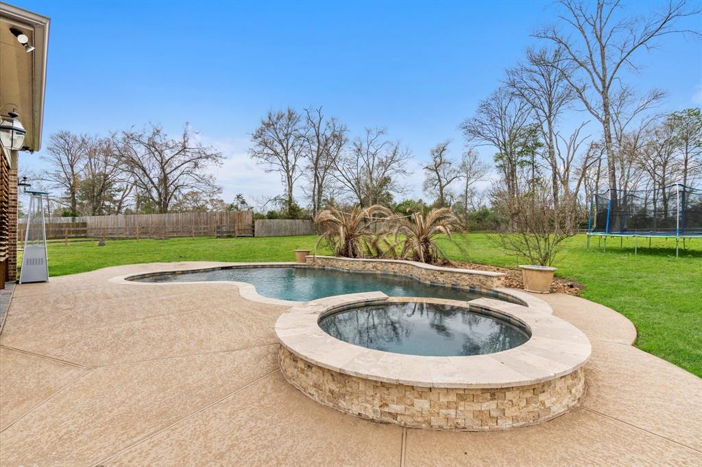 a view of a swimming pool with a yard