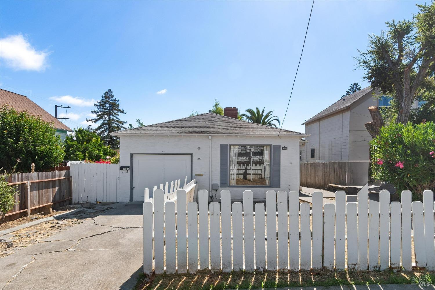 a front view of house with wooden fence