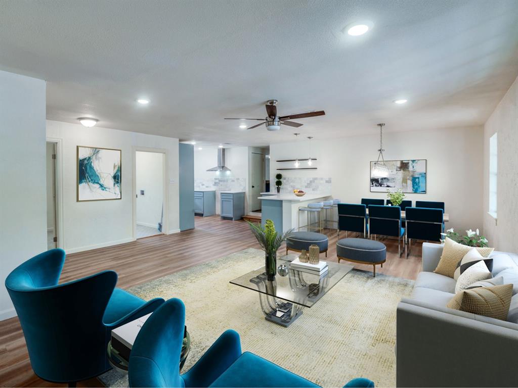 a living room with lots of furniture and kitchen view